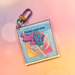 A blue crystal colored game cartridge keychain, retro themed with a character coming out of it